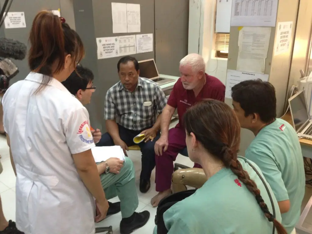 A clinical team in discussion during a surgical mission in Cambodia